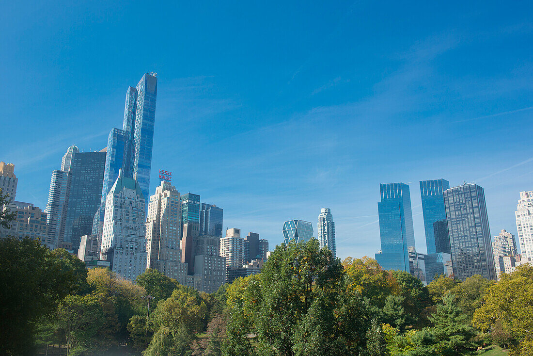 Buildings along Central Park South will Wollman Rink in Central Park, New York City, NY