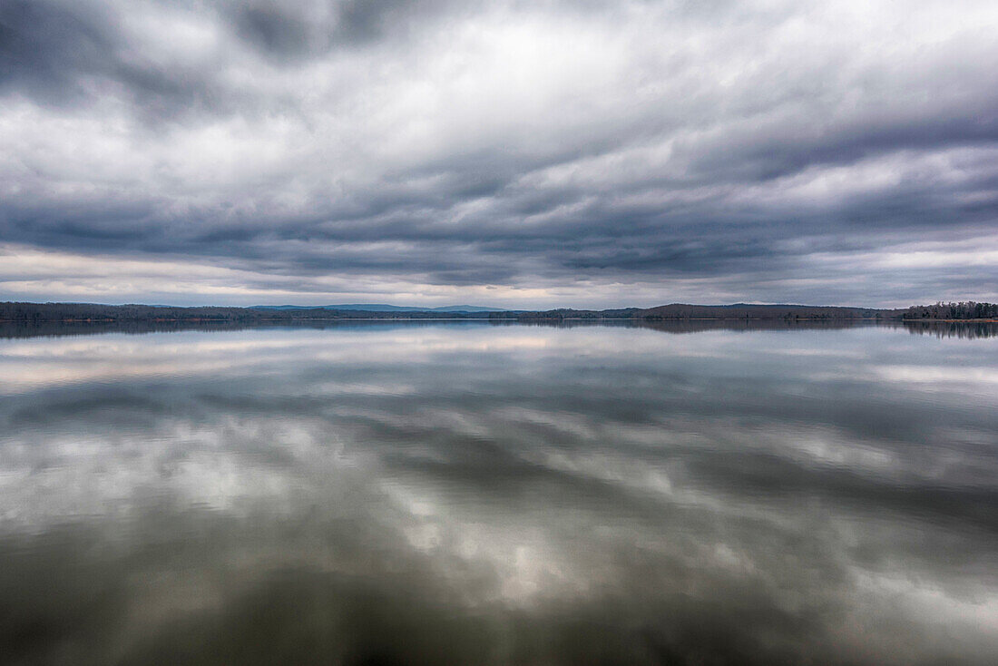 USA, Tennessee. Ten Mile. Calm before the storm. Storm clouds reflected in glass calm lake