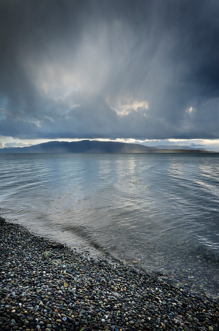 Stormy winter clouds over Bellingham Bay, Washington State. Lummi Island in the distance.