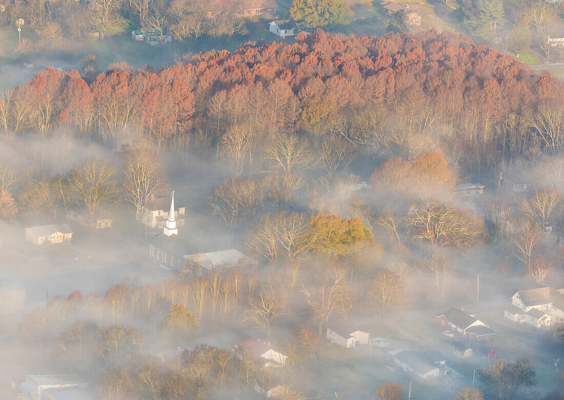 USA, Tennessee. Church steeple rises above fog.