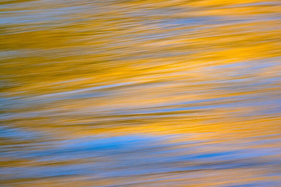 Sunset colors and trees reflecting on Snake River, Grand Teton National Park, Wyoming