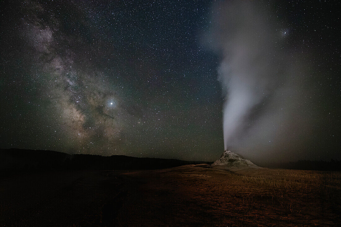 USA, Wyoming, Yellowstone National Park. Milky Way above erupting White Dome Geyser