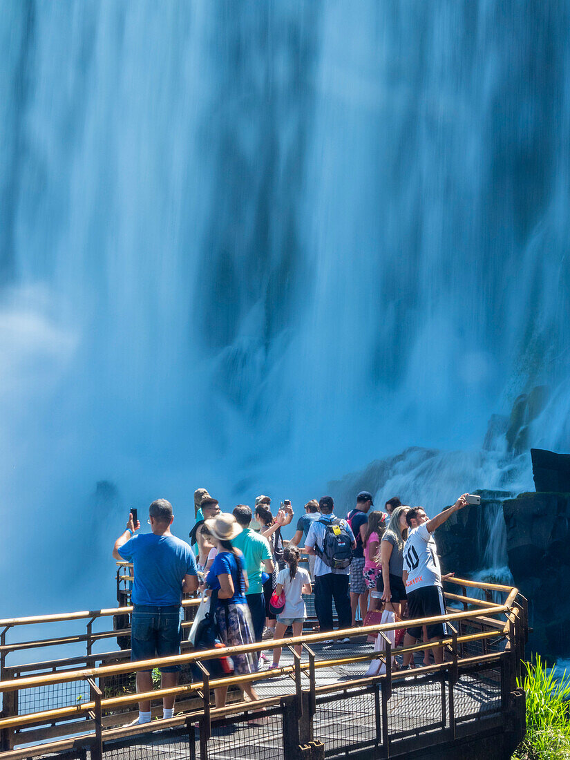 Tourists on a platform on the lower circuit at Iguazu Falls, UNESCO World Heritage Site, Misiones Province, Argentina, South America