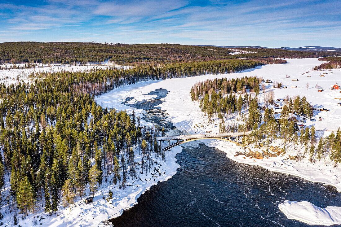 Aerial view of bridge above the scenic Jockfall waterfall in winter, Overkalix, Norrbotten county, Lapland, Sweden, Scandinavia, Europe