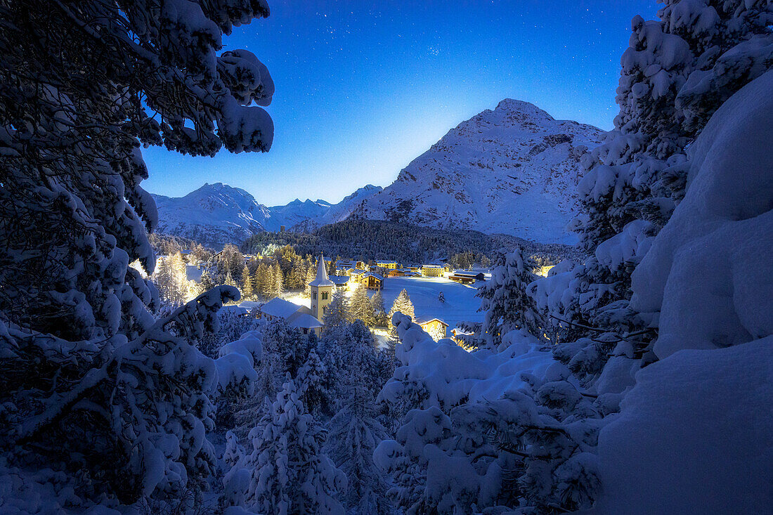 Märchenhafter Blick auf die verschneite Chiesa Bianca in einer sternenklaren Winternacht, Maloja, Bergell, Engadin, Kanton Graubünden, Schweiz, Europa