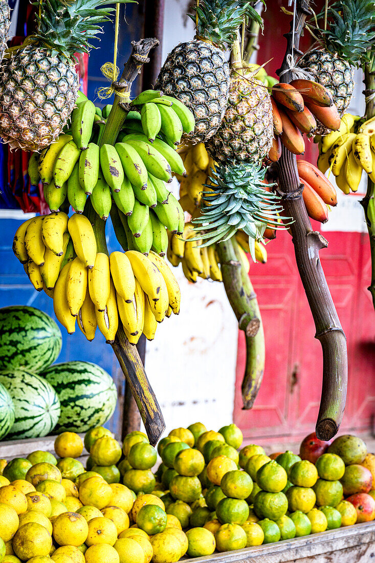 Exotic fruit hanging outdoors in a local shop, Zanzibar, Tanzania, East Africa, Africa