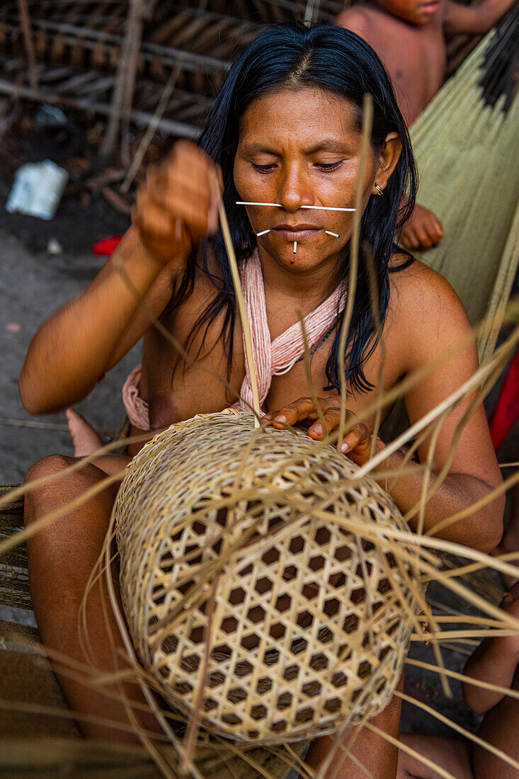 Frau vom Stamm der Yanomami beim Flechten eines Korbes, Südvenezuela, Südamerika