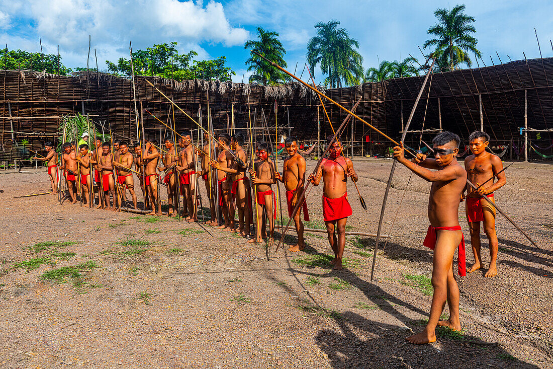Men practising shooting their bows and arrows, Yanomami tribe, southern Venezuela, South America