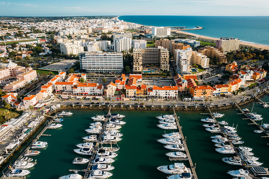Aerial view of the tourist Portuguese town of Vilamoura, with yachts and sailboats moored in the port on the marina, Vilamoura, The Algarve, Portugal, Europe