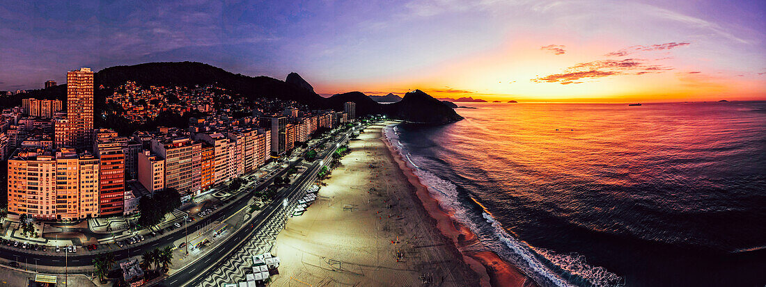 Panoramic aerial drone view of Leme Beach in the Copacabana district at sunrise with the iconic Sugarloaf Mountain in the background, UNESCO World Heritage Site, Rio de Janeiro, Brazil, South America