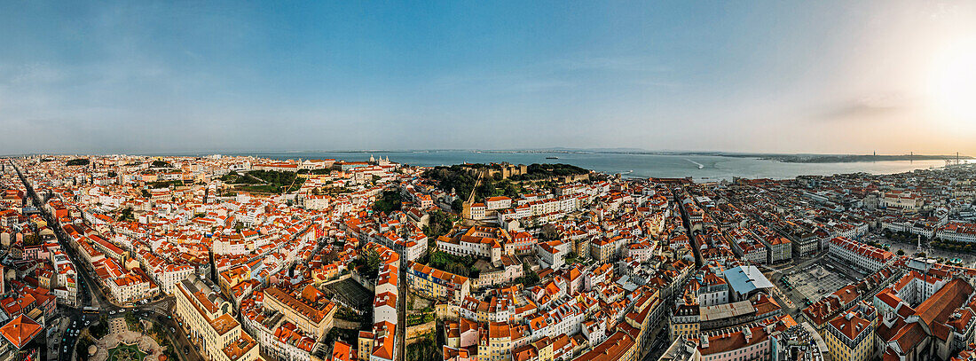 Aerial drone view of Baixa District, facing south towards the Tagus River with the major landmarks visible including St. George Castle, Pantheon, Figueira, Rossio Square, Martim Moniz Squares, Lisbon, Portugal, Europe