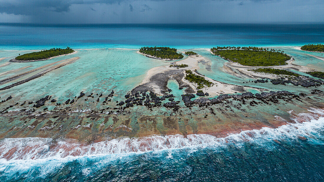 Aerial of the elevated reefs of Ile aux Recifs, Rangiroa atoll, Tuamotus, French Polynesia, South Pacific, Pacific