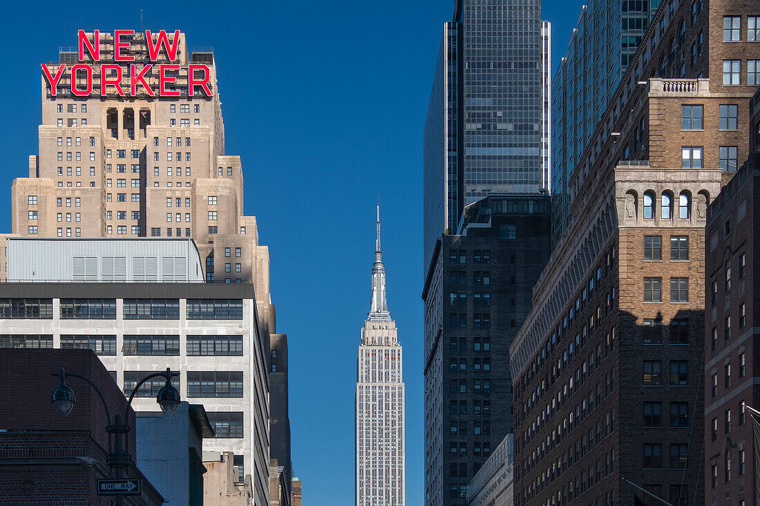 The New Yorker Hotel and Empire State Building viewed along 34th Street, Garment District, Manhattan, New York, United States of America, North America