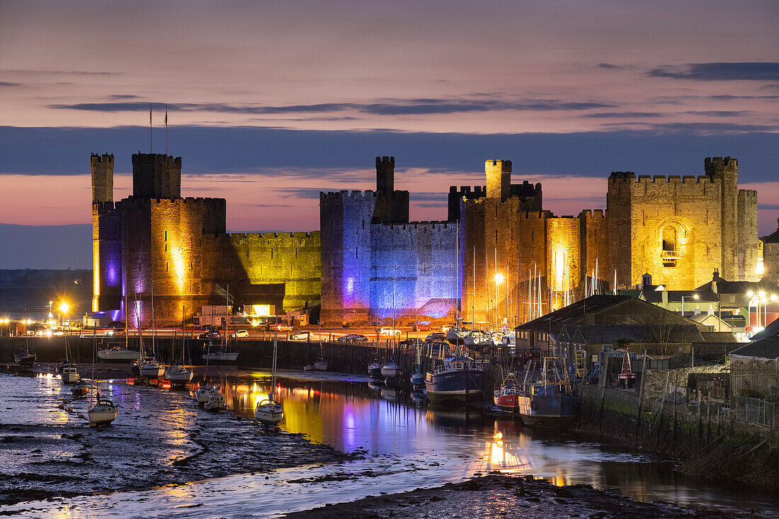 Caernarfon Castle, UNESCO World Heritage Site, and the Seiont Estuary at night, Caernarfon, Gwynedd, North Wales, United Kingdom, Europe