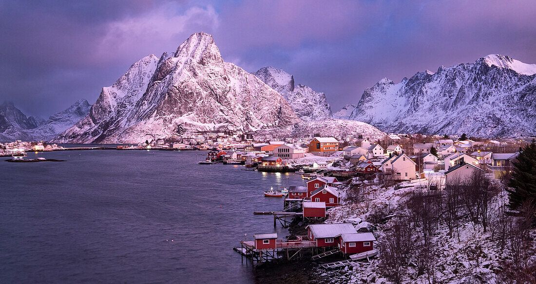 Das Fischerdorf Reine und der Berg Olstinden in der Morgendämmerung im Winter, Kommune Moskenes, Landkreis Nordland, Lofoten, Norwegen, Skandinavien, Europa