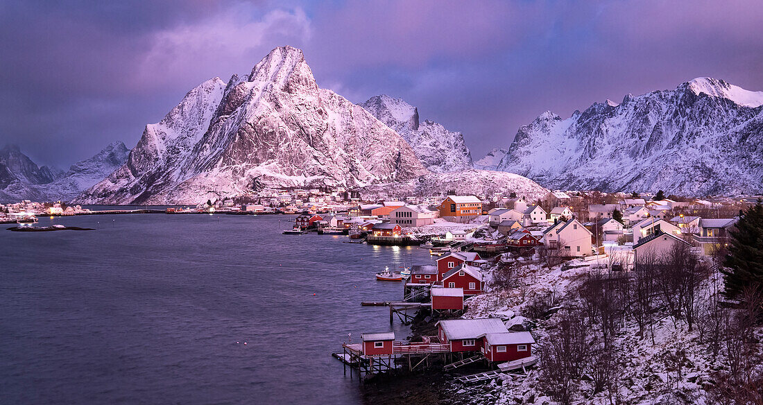 The fishing village of Reine and Olstinden mountain at dawn in winter, Moskenes Municipality, Nordland County, Lofoten Islands, Norway, Scandinavia, Europe