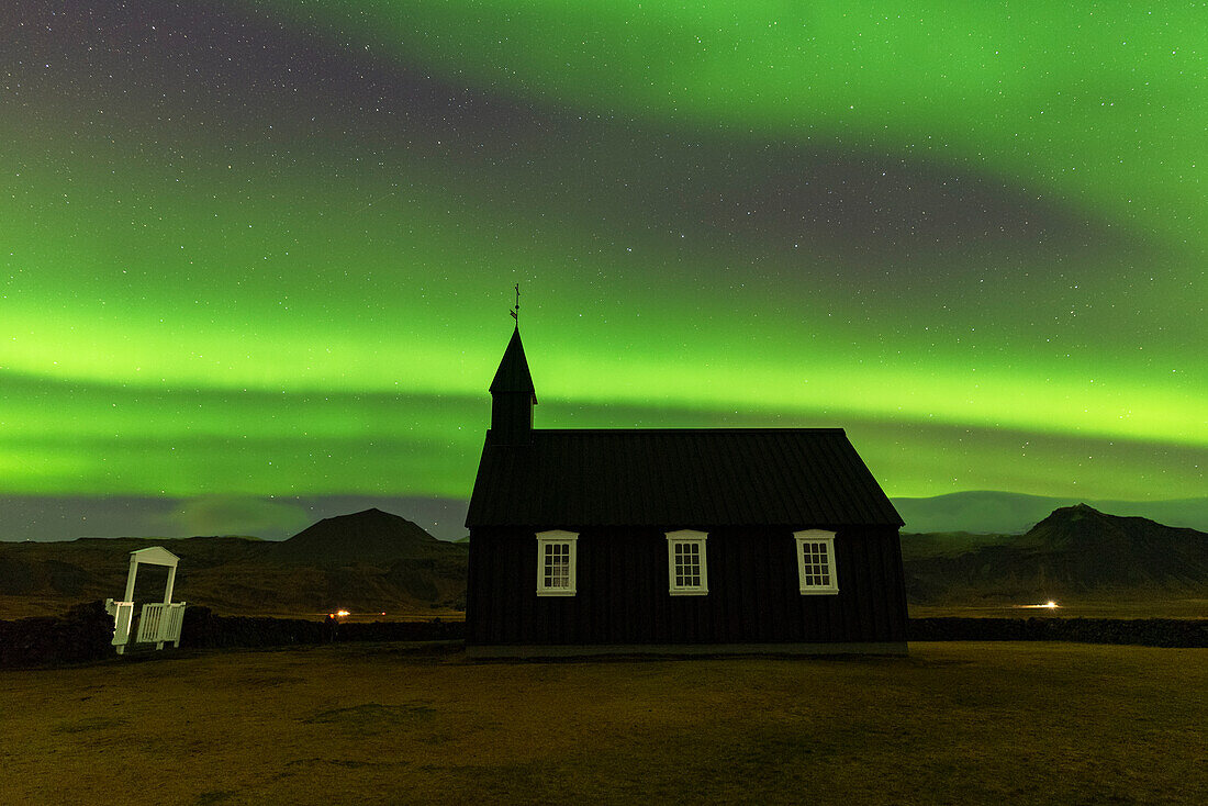 Black wooden Budakirkja church under the green Northern Lights (Aurora Borealis) and the starry night, Budir, Snaefellsness Peninsula, Vesturland, West Iceland, Iceland, Polar Regions