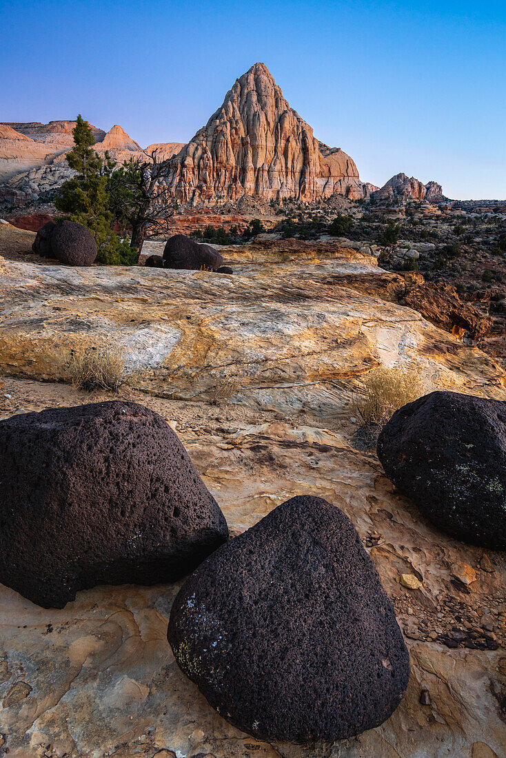 Lava stones and Pectol's Pyramid at dusk, Capitol Reef National Park, Utah, Western United States, United States of America, North America