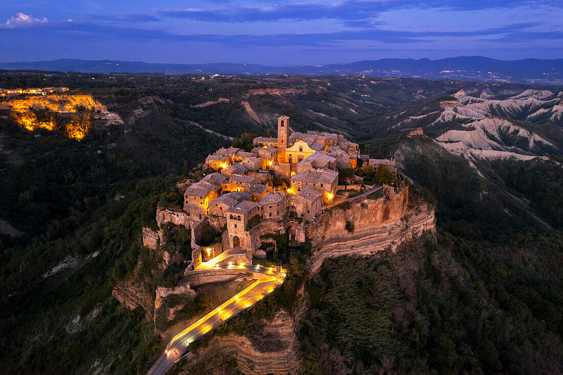 Aerial view of the medieval village of Civita di Bagnoregio lit at dusk, Viterbo province, Latium (Lazio), Italy, Europe