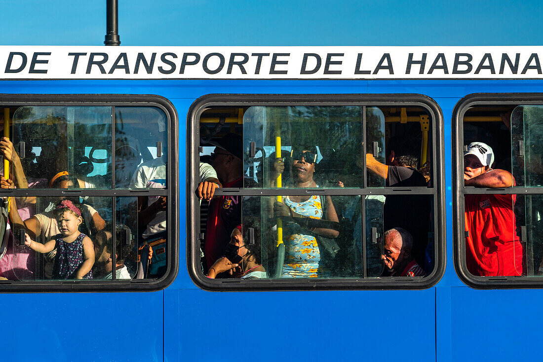 People in packed public bus seen through windows, Havana, Cuba, West Indies, Caribbean, Central America