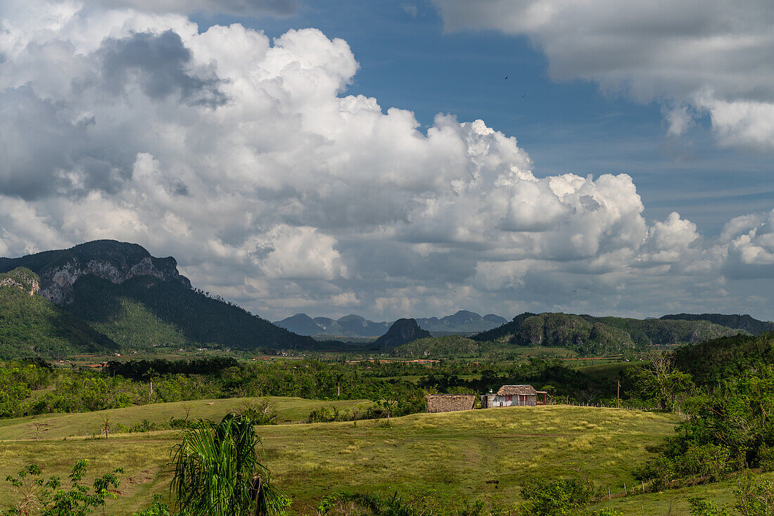 Small hut in valley under dramatic cloudscape near Vinales, Cuba, West Indies, Caribbean, Central America