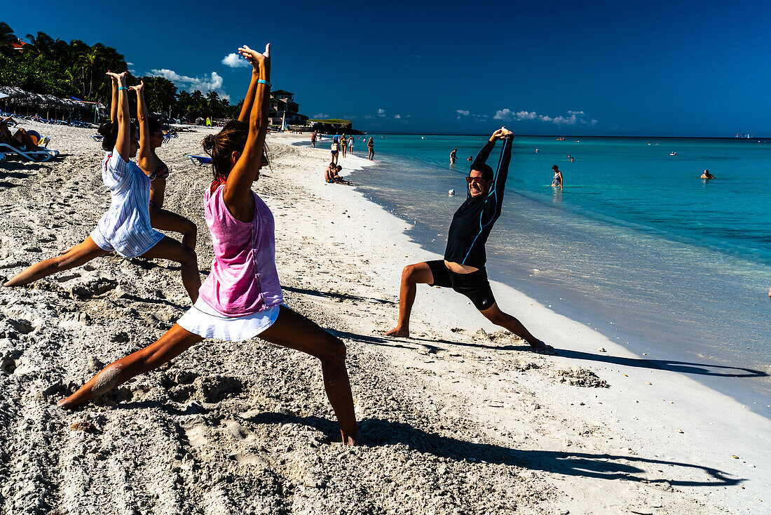 Enthusiastic stretching class to keep fit on the beach, Varadero, Cuba, West Indies, Caribbean, Central America