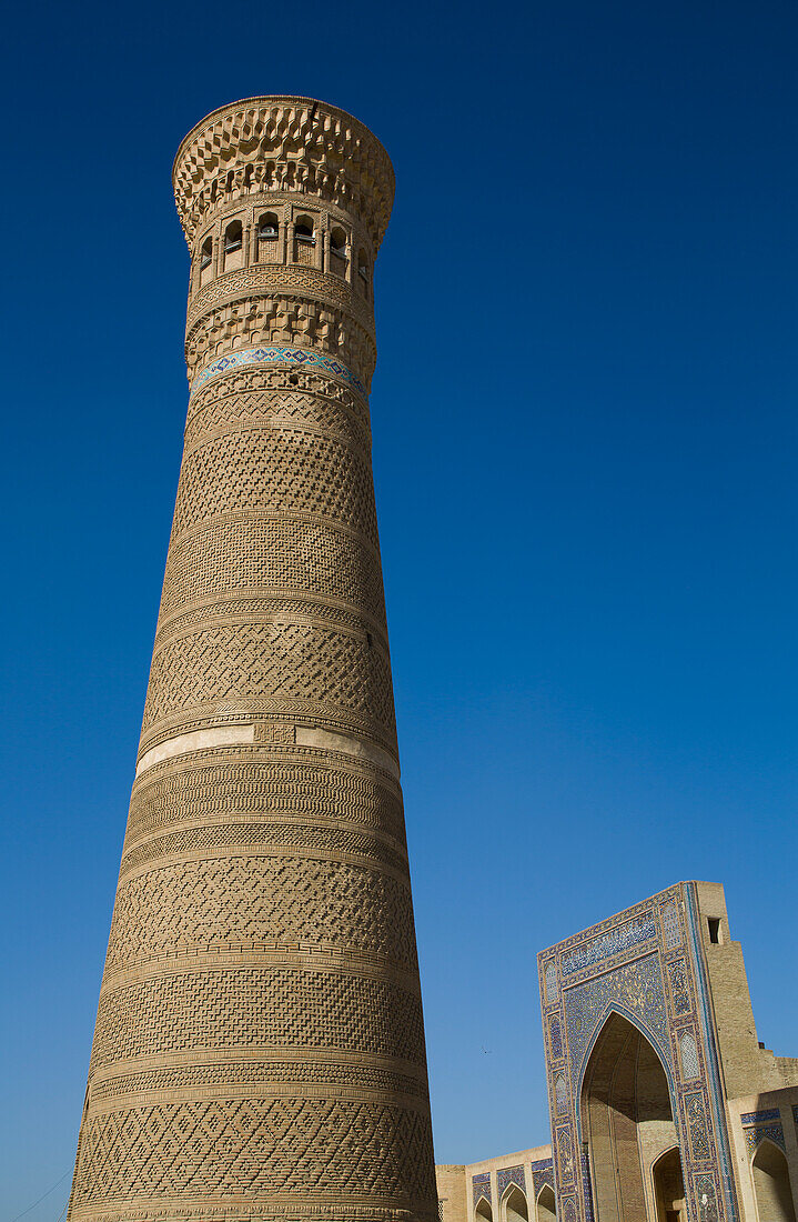 Kalyon Minar (Great Minaret), Mir-I Arab Madrasah in the background, Poi Kalyon Square, UNESCO World Heritage Site, Bukhara, Uzbekistan, Central Asia, Asia