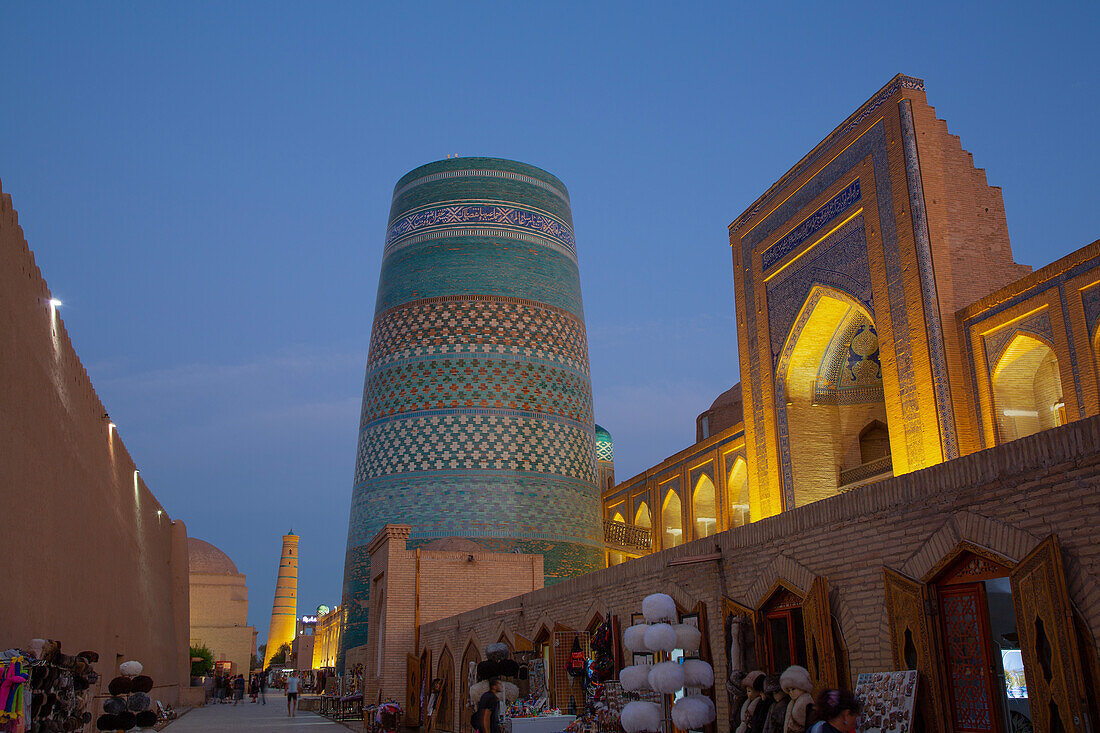 Evening, Kalta Minaret on left, Muhammad Amin Khan Madrasah (Orient Star Hotel) on the right, Ichon Qala (Itchan Kala), UNESCO World Heritage Site, Khiva, Uzbekistan, Central Asia, Asia