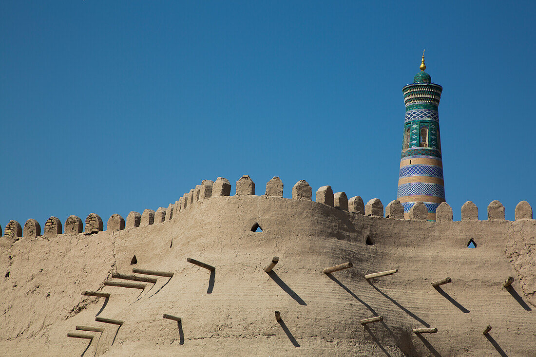 Fortress Wall, Islam Khoja Minaret in the background, Ichon Qala (Itchan Kala), UNESCO World Heritage Site, Khiva, Uzbekistan, Central Asia, Asia