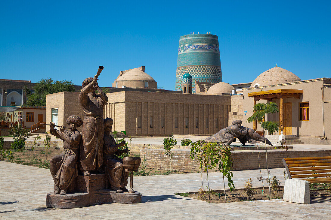 Sculpture with Kalta Minaret in the background, Ichon Qala (Itchan Kala), UNESCO World Heritage Site, Khiva, Uzbekistan, Central Asia, Asia