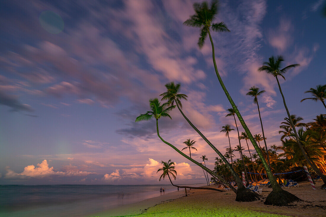 View of palm trees and sea at Bavaro Beach at sunset, Punta Cana, Dominican Republic, West Indies, Caribbean, Central America