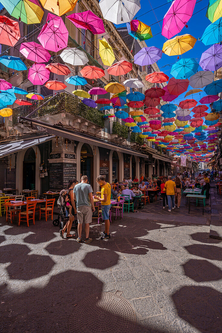 View of colourful umbrellas and restaurants on Via Gisira, Catania, Sicily, Italy, Mediterranean, Europe