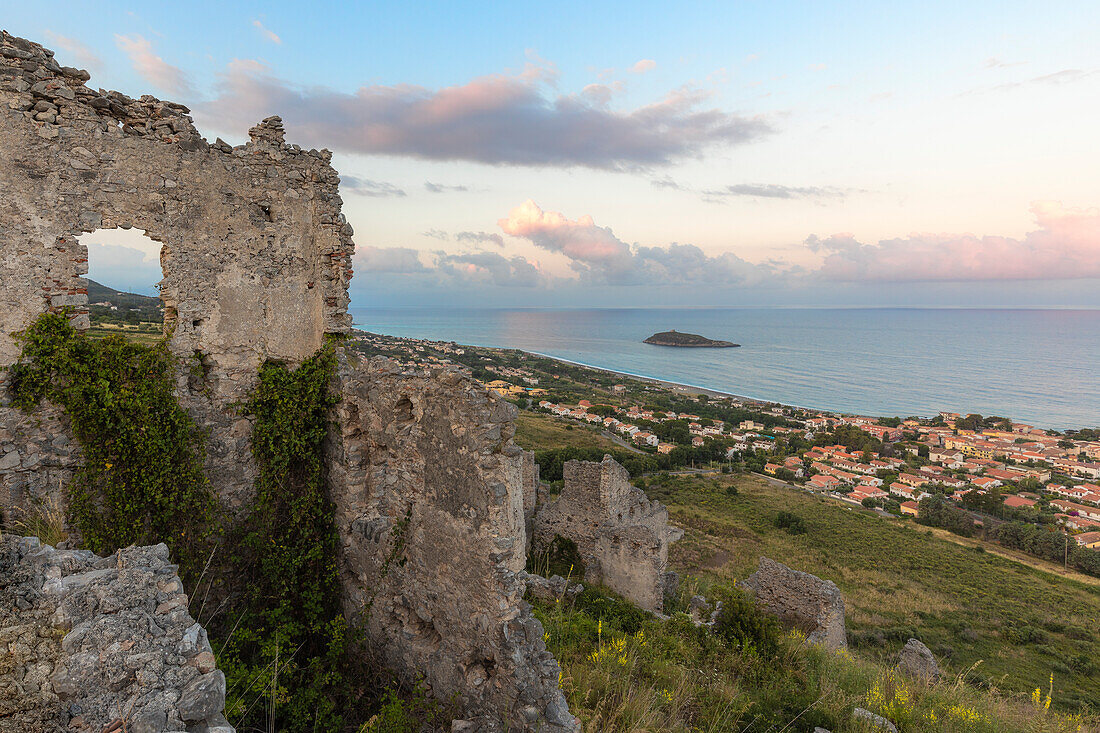 The typical medieval village of Cirella, in the background the homonymous island of Cirella at sunrise, Diamante, province of Cosenza, Italy, Europe