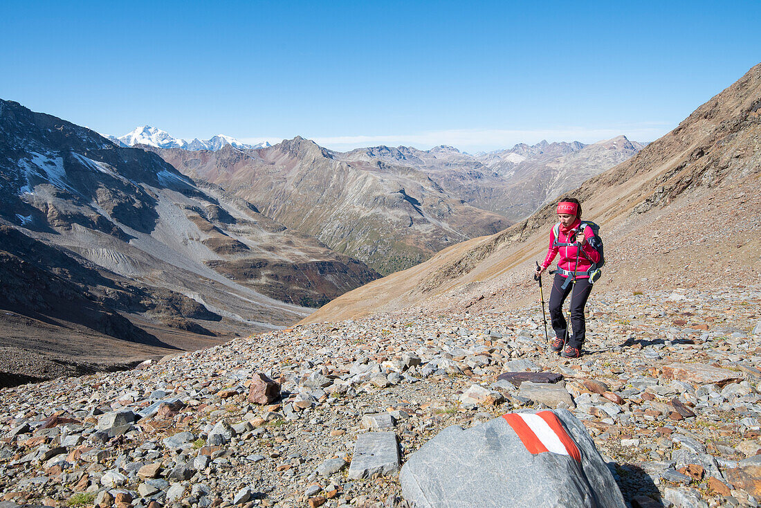 A girl is walking in hight mountain of Val Nera, Livigno, Sondrio Province, Valtellina, Lombardy, Italy, Europe