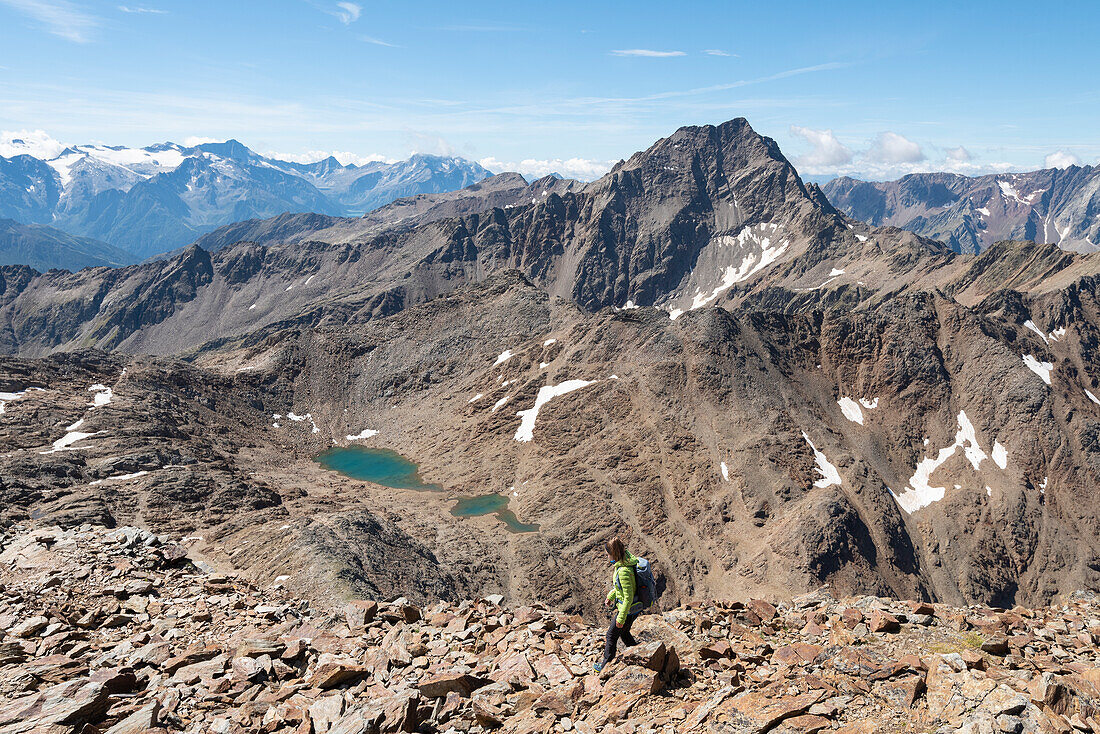 Girl walks on the track of Piz Vallumbrina, Gavia Valley, Valtellina, Sondrio Province, Lombardy, Italy, Europe