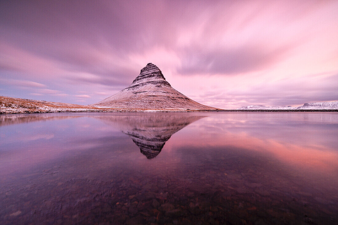 Langzeitbelichtung, um den Berg Kirkjufell, der sich in einer kleinen Lagune spiegelt, während eines winterlichen Sonnenaufgangs einzufangen, Snaefells Halbinsel, Vesturland, Island, Europa