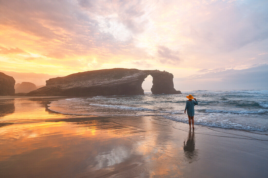 one tourist enjoy an amazing summer sunset at Praia at Catedrais during a low tide, Galixia, Spain, Europe