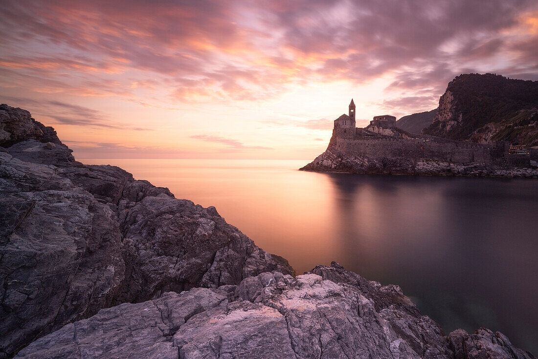 a long exposure to capture the warm sunset at iconic San Pietro Church, municipality of Portovenere, La spezia province, Liguria district, Italy, Europe