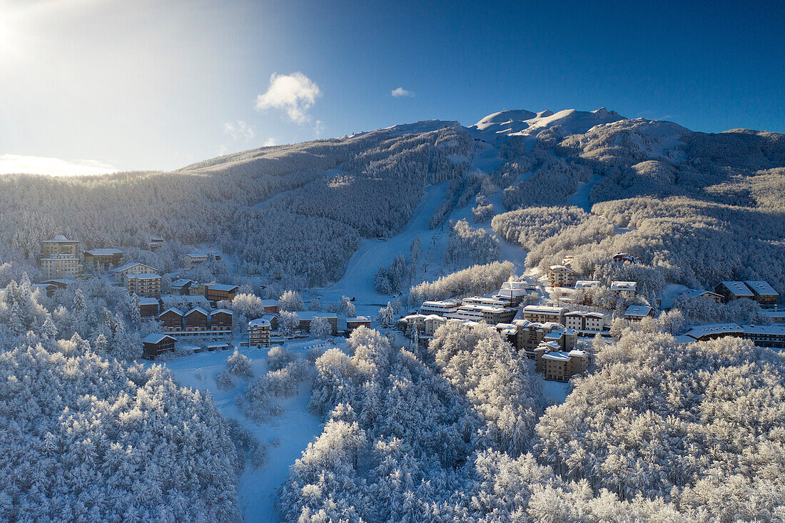 an aerial drone view of the Cerreto Laghi ski resort, during a beautiful winter morning, Tuscan-Emilian apennine national park, municipality of Ventasso, Reggio Emilia province, Emilia Romagna district, Italy, Europe