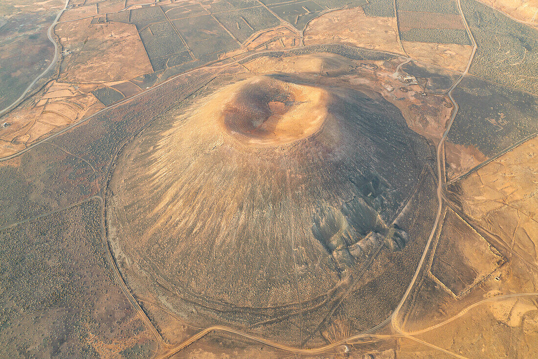 aerial vertical view taken by drone of the Montaña Negra Volcano, Natural Park of Corralejo, shooted during a summer day, Fuerteventura, Canary Island, Spain, Europe