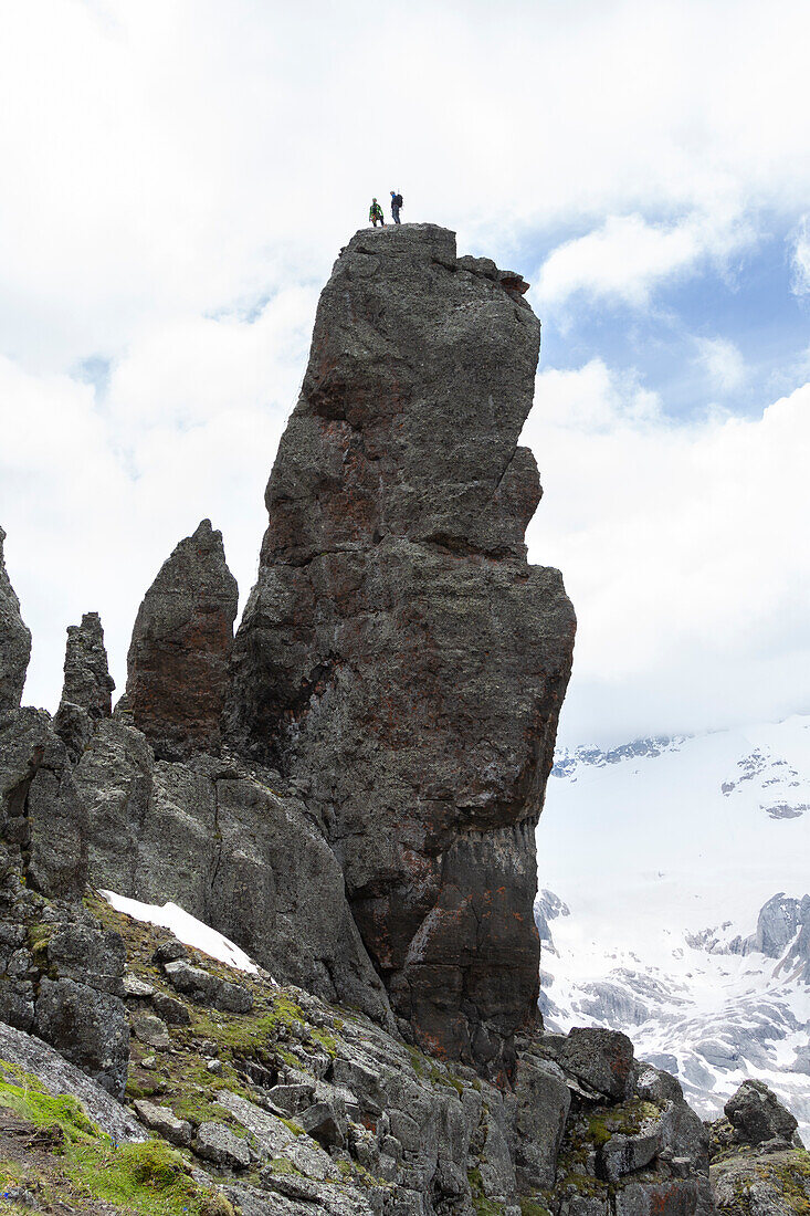 Two mountaineers on the top of the Hermit's Tower (Torrione dell'Eremita) along the Via Ferrata delle Trincee, Padon Group, Dolomites, Fassa Valley, Trento Province, Trentino-Alto Adige, Italy.