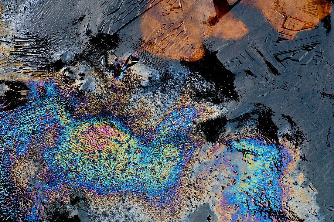 Colourful abstract oil patterns on ice.