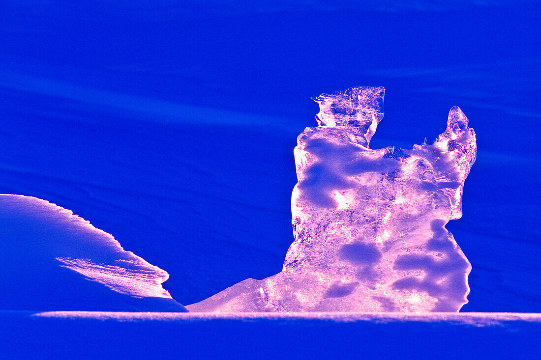 Sunset shining through ice shaped like wrestling polar bears, Lake Manitoba, MB