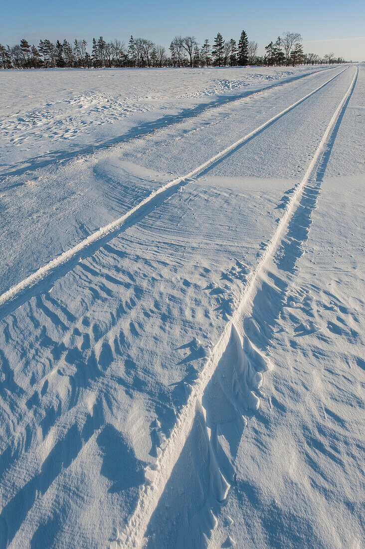 Kanadische Prärie-Landstraße nach Schneefall.