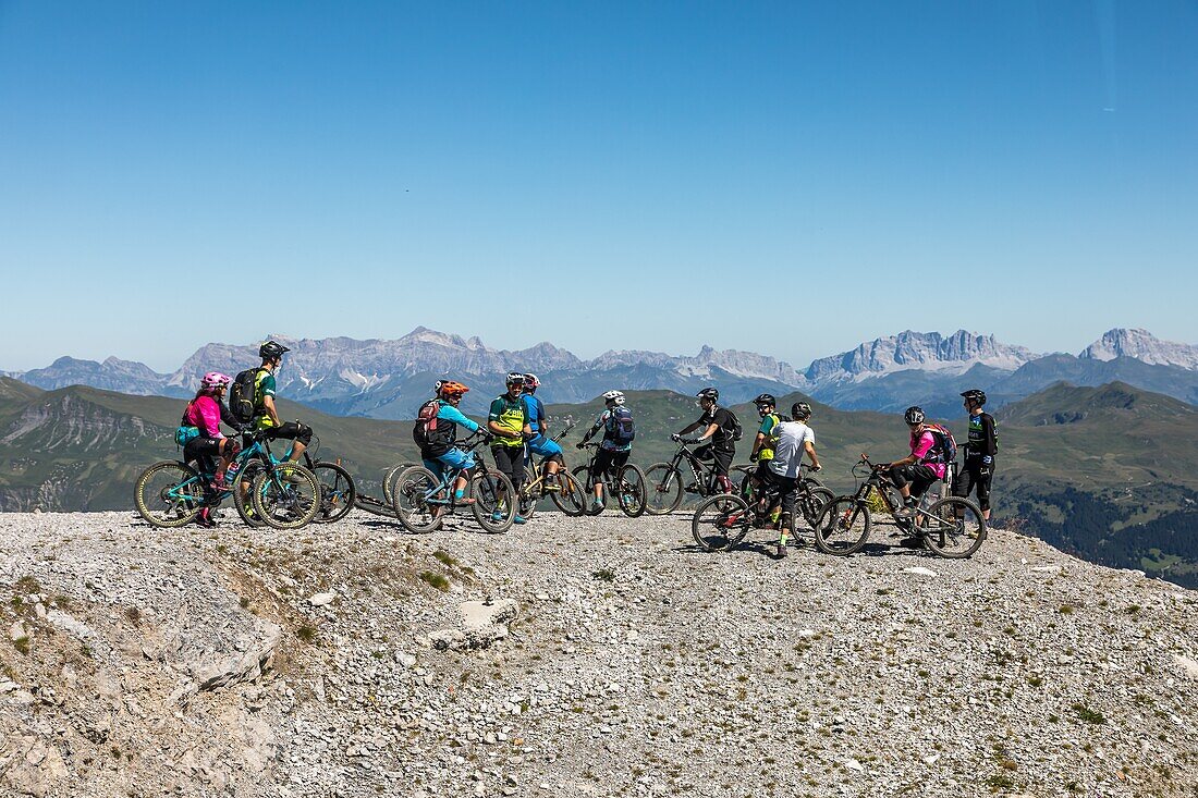 Mountain bikers heading off on a trek on the heights of the weisshorn in the swiss alps, active seniors, tourism, resort of arosa, canton of the grisons, switzerland