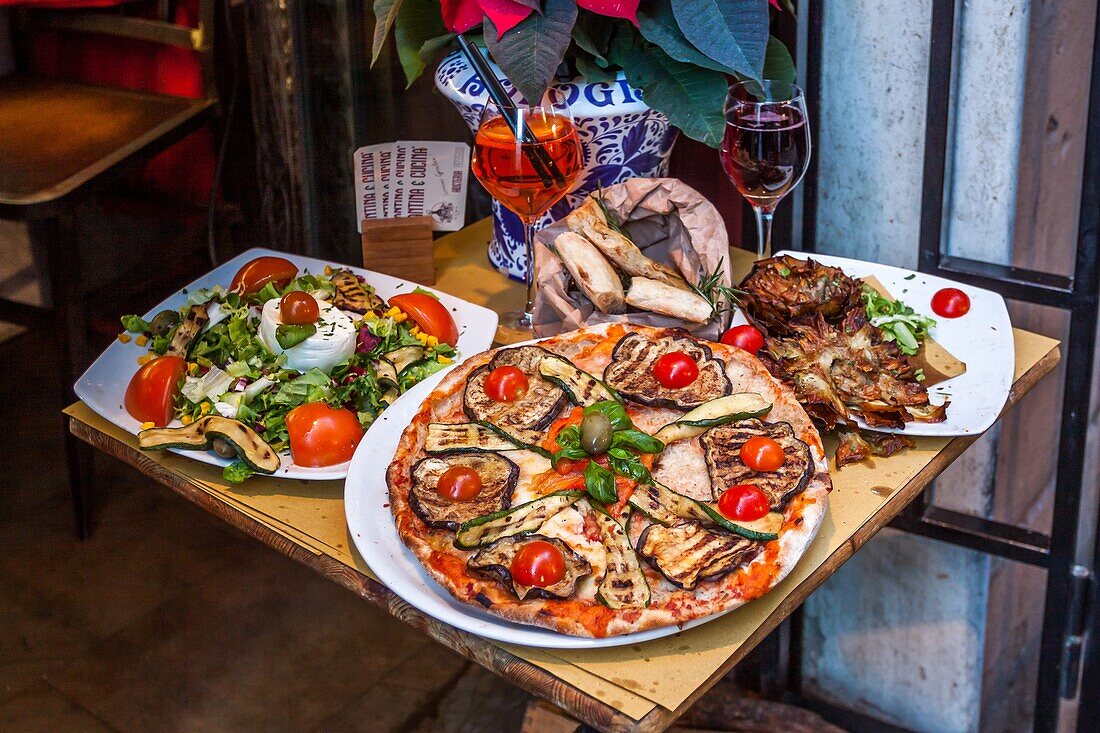 Example of pizzas at the entrance to an italian restaurant in rome, roman gastronomy,  aperol spritz cocktail, rome, italy