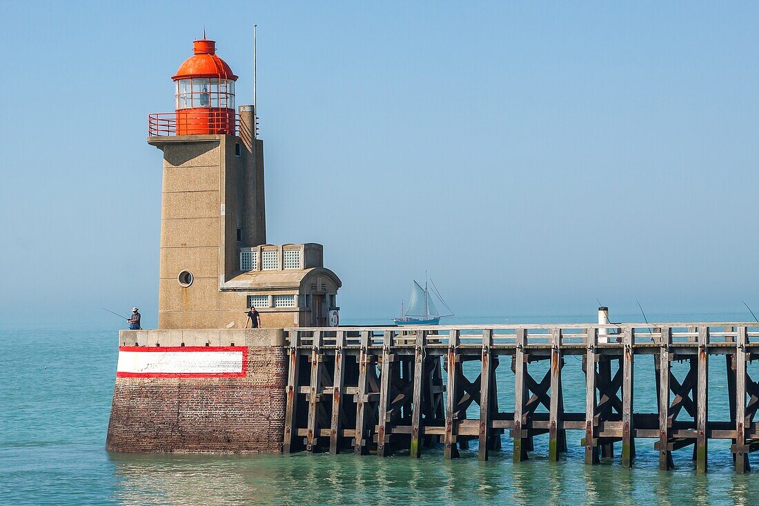 Entrance to the port of fecamp with fishermen on the jetty of the fecamp lighthouse, ecamp, seine-maritime, normandy, france