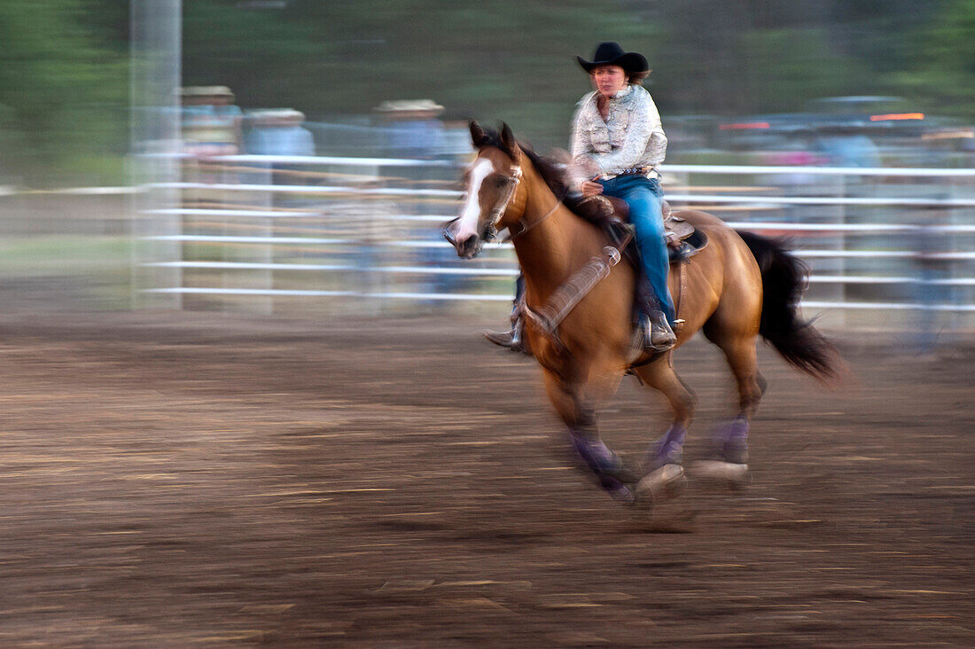 Horse and rider in rodeo barrel racing event.