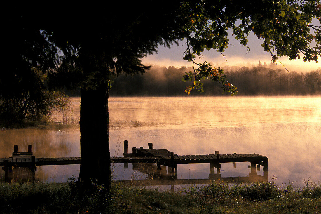 Sunrise mist and boat dock over Lake of the Woods near Warroad Minnesota USA