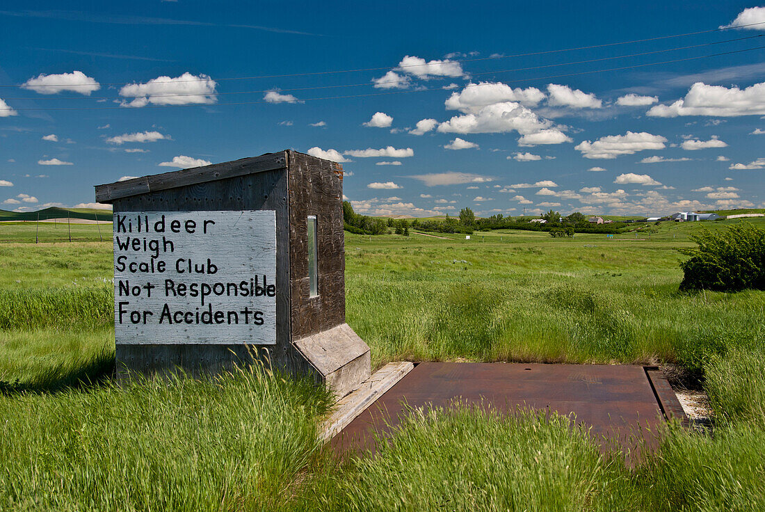 Sign on prairie weigh scale for trucks.